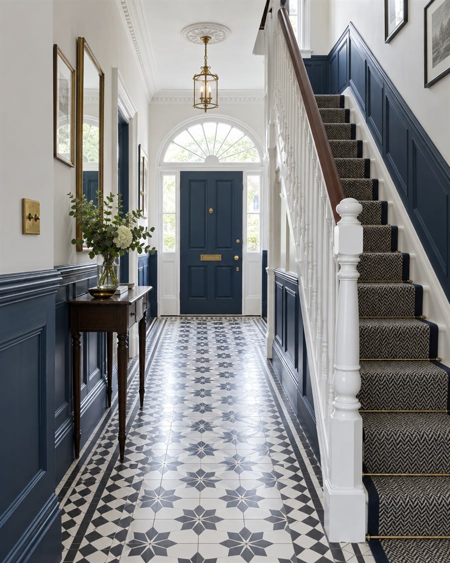 Hallway with deep navy panelling and a white staircase